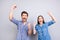 Yes! We did it! Cheerful couple is celebrating with raised hands