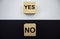 Yes and no, text on wooden cubes on a white and black background. The concept of choice. Positive and negative