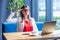 Yes sir! Portrait of serious stylish brunette young woman in glasses sitting, looking at camera and giving salute on boss command