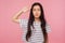 Yes sir! Responsible serious girl with brunette hair in striped t-shirt giving salute with attentive look