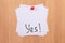 YES! - White Sticky Notes with Written Word YES, Pinned to the Wooden Message Board