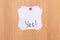 YES! - White Sticky Notes with Written Word YES, Pinned to the Wooden Message Board