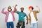 Yes. Winners. Three cheerful young men are standing and gesturing for the victory on white background in casual outfit and jeans.