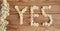 YES wrote with daisies on wooden background