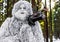 Yeti fairy tale character in winter forest. Outdoor fantasy photo.