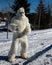 Yeti standing on snowmobile trail