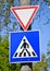 Yield and pedestrian traffic signs on a pole