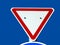 Yield. road traffic sign. red and white triangle. blue sky