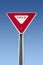 Yield sign on blue sky