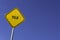 Yield - yellow sign with blue sky background