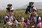 Yiliang, China - March 24, 2019: Black Yi people dressed in a traditional attire picking up tea leaves in Baohong mountain,