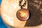 Yin Yang pendant necklace brown color handmade shoot outside in a sunny day closeup. Selective Focus