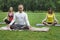 Yoga athletes in park - sportsmen in lotus pose