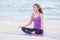 Yoga beach,Asia woman close eyes and doing Hand Mudra pose and m