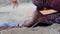 Yoga on the beach. Close-up of girls legs in lotus position. Blurred background for signature. Doing sports, Pilates, stretching o