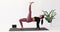 Yoga brunette woman performs a variation of the Purvottanasana exercise, inverted table pose with straight leg lifting up