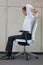 Yoga on chair in office - business man exercising