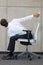 Yoga on chair in office - business man exercising