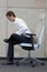 Yoga on chair in office - business man exercising