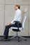 Yoga on chair in office - business man exercising