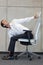 Yoga on chair in office - business man exercising