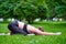 Yoga Child Pose - Balasana. Young woman practicing yoga meditation in nature at the park. Health lifestyle concept