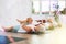 At yoga class elderly woman is lying on back, bent one leg at knee and raised it to chest