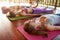 Yoga class lying in the Corpse pose, Savasana