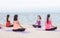 Yoga class at sea beach in evening sunset ,Group of asia people