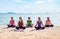 Yoga class at sea beach in sunny day ,Group of people doing lotus pose with relax emotion,Meditation pose,Wellness and