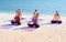 Yoga class at sea beach in sunny day ,Group of people doing lotus pose with relax emotion,Meditation pose,Wellness and