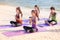 Yoga class at sea beach in sunny day ,Group of people doing namaste pose with relax emotion,Meditation pose,Wellness and