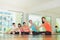 Yoga class in studio room,Group of people doing seated side stretch right poses with calm relax