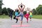 Yoga classes outdoors with multiracial group in different physic