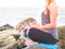 Yoga concept. Closeup woman hand practicing lotus pose on the beach at sunset