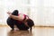 Yoga Concepts. Caucasian Woman Practicing Yoga Exercise Indoors At Bright Afternoon. Sitting in Marichiasana Pose