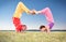 Yoga couple, man and woman doing Vrschikasana scorpion pose