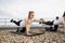 Yoga enthusiasts practicing balance pose on roof terrace