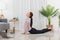 Yoga exercise concept, Asian woman doing yoga with lying in cobra pose and watching tutorial online