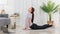 Yoga exercise concept, Asian woman doing yoga with lying in cobra pose and watching tutorial online