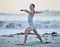 Yoga, exercise and fitness woman at beach for warrior pose for balance, zen and peace during nature workout for health