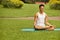 Yoga Exercise. Portrait of athletic man doing a yoga at summer p