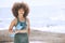 Yoga, fitness and beach with a black woman athlete by the sea with her exercise mat for a workout. Nature, water and