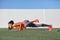 Yoga fitness girl training triceps doing advanced push-up chaturanga with leg side crunch spiderman pose. Pushup exercise