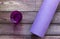 Yoga , fitness mat with glass of water on wooden floor