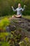 Yoga girl with view of the forest, with sunlight. Young woman in
