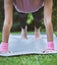 Yoga, hands and mat with a woman plank closeup outdoor in a grass park for workout or training. Wellness, health and