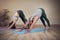 Yoga heals the soul. Full length shot of two unrecognizable yogis holding a downward facing dog during an indoor yoga