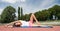 Yoga helps find harmony. Woman flexible body practice yoga lay fitness mat outdoors nature background. Girl stretching