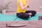 Yoga at home. Concept of online fitness classes. In the foreground is a burning incense, in the background is a blurred silhouette